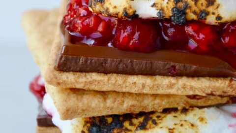 Stack of s'mores with chocolate and raspberries