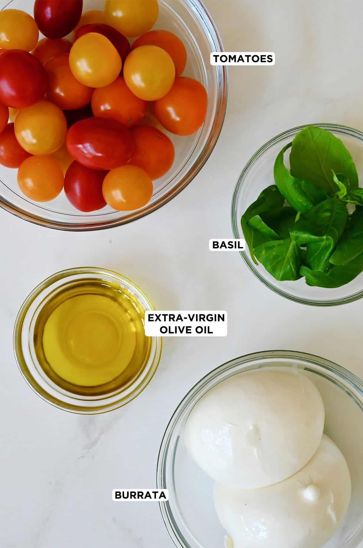 Caprese salad ingredients with burrata cheese and cherry tomatoes.