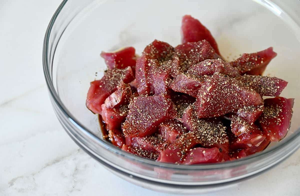 Pork tenderloin pieces in a pepper marinade.