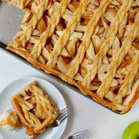A caramel apple slab pie with a piece cut out