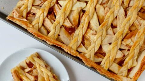 A caramel apple slab pie with a piece cut out