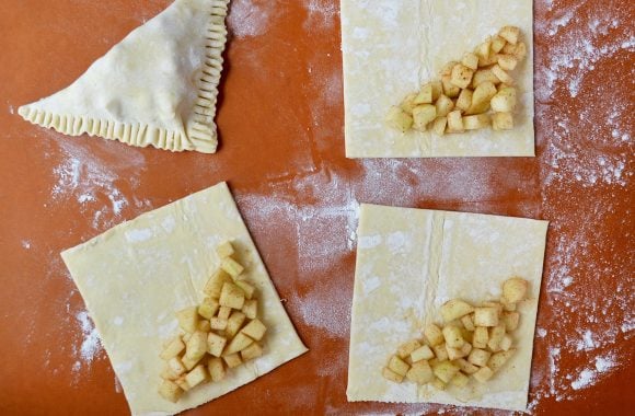 Square puff pastry dough with apple turnover filling