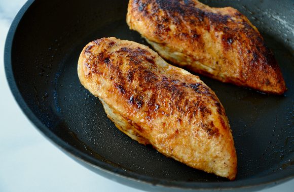 Seared chicken breasts in nonstick skillet