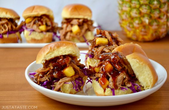 Slow Cooker Hawaiian Pulled Pork with purple cabbage on buttery buns atop a white plate