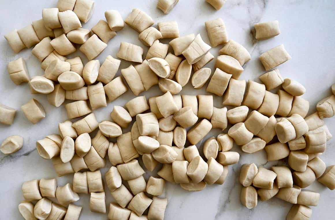 A top-down view of unbaked pieces of pretzel dough