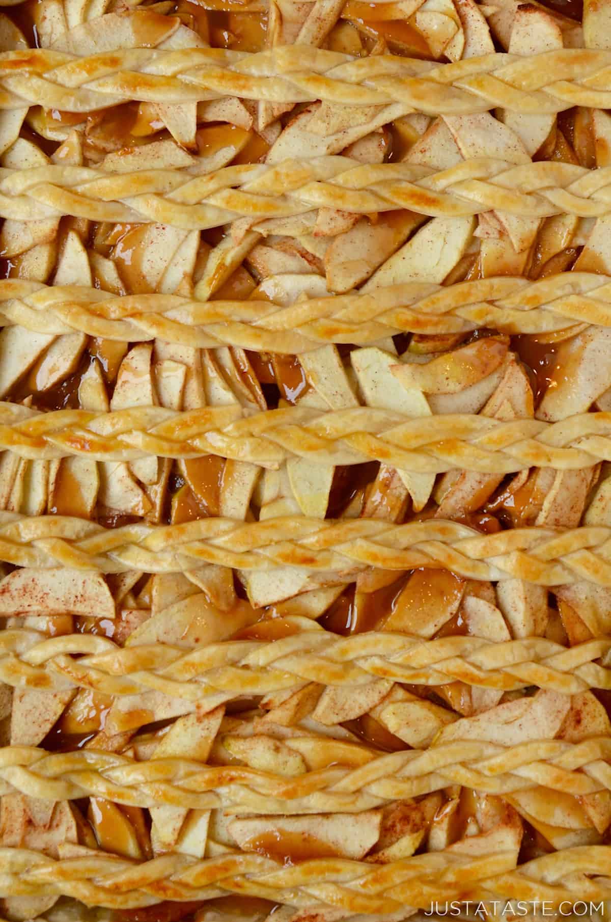 A sheet pan with the finished golden brown caramel apple slab pie.
