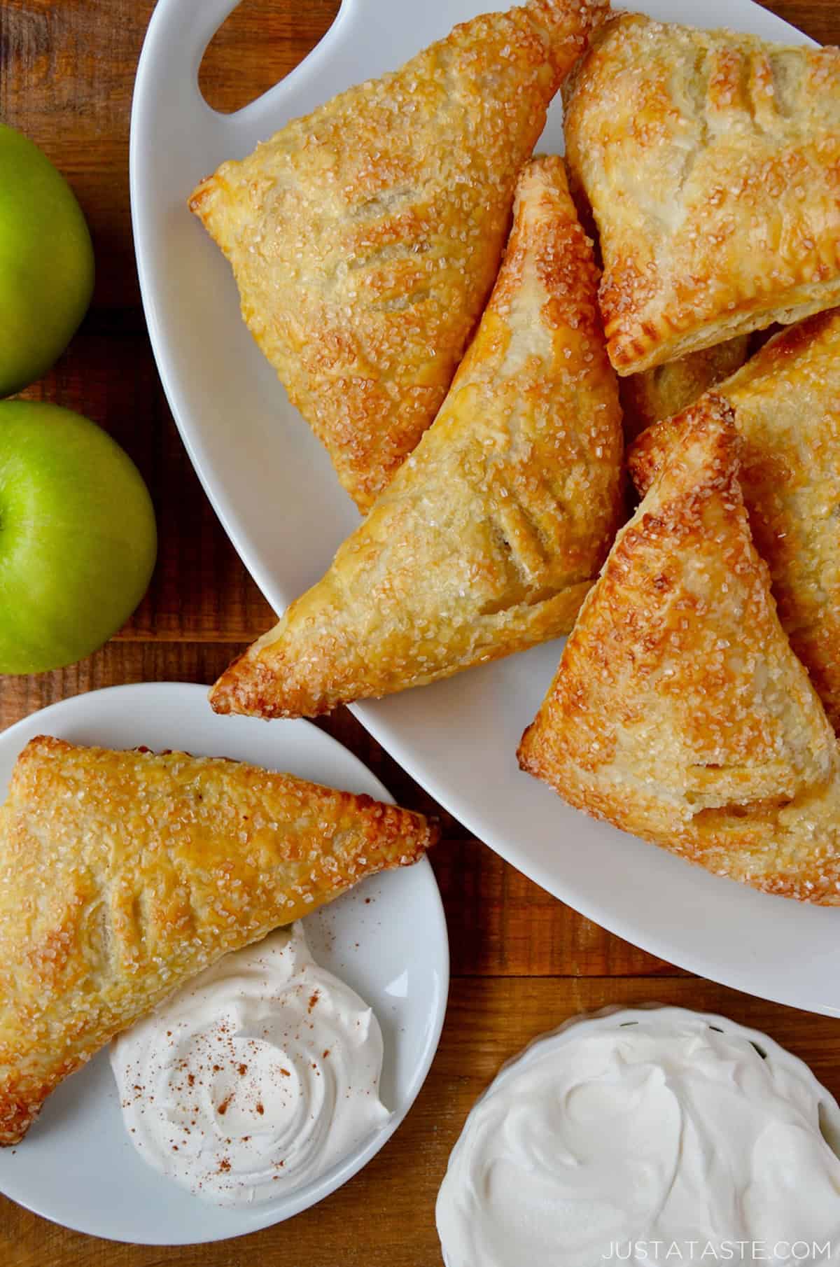 Easy Apple Turnovers on serving plate with whipped cream.