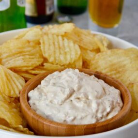 Homemade Sour Cream and Onion Dip with potato chips on serving tray