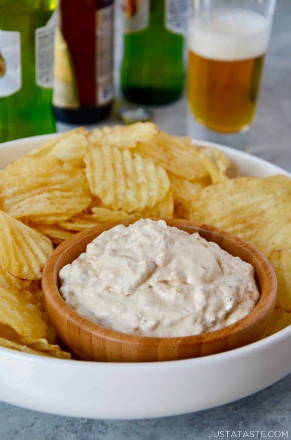 Homemade Sour Cream and Onion Dip with potato chips on serving tray