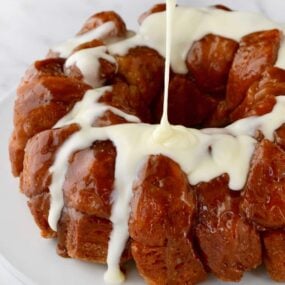 Monkey Bread with Cream Cheese Glaze being poured over top