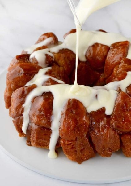 Monkey Bread with Cream Cheese Glaze being poured over top