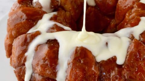 Monkey Bread with Cream Cheese Glaze being poured over top