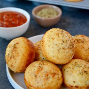 Muffin Tin Pizza Pockets on plate with marinara sauce