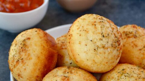 Muffin Tin Pizza Pockets on plate with marinara sauce