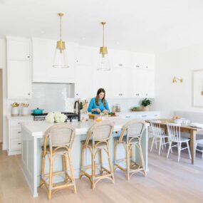 The Just a Taste kitchen remodel with Kelly standing at the kitchen island