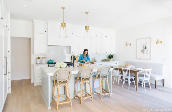 The Just a Taste kitchen remodel with Kelly standing at the kitchen island