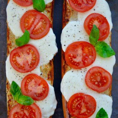 A top down view of two halves of Caprese Garlic Bread