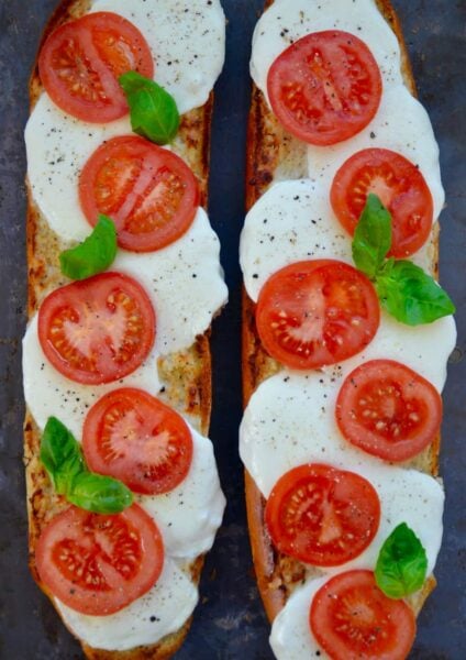 A top down view of two halves of Caprese Garlic Bread