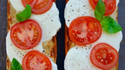 A top down view of two halves of Caprese Garlic Bread