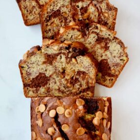 A top down view of a loaf of Chocolate Peanut Butter Banana Bread cut into slices