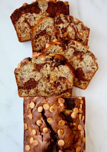 A top down view of a loaf of Chocolate Peanut Butter Banana Bread cut into slices