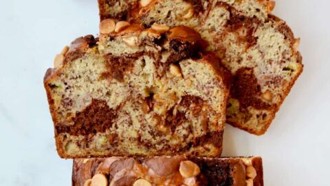 A top down view of a loaf of Chocolate Peanut Butter Banana Bread cut into slices