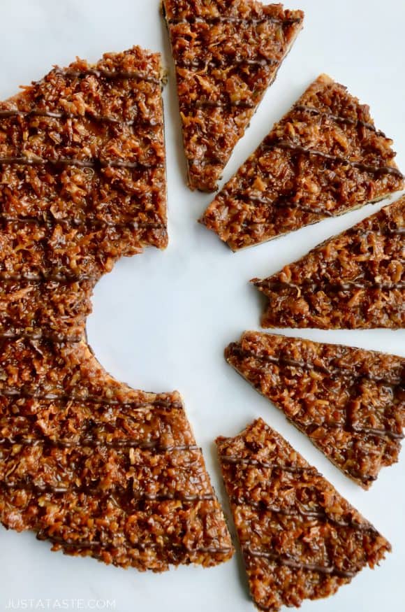 A top down view of a Giant Samoas Cookie Cake with one half cut into slices