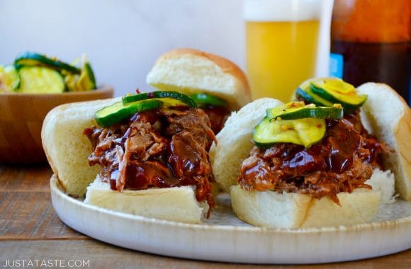 Instant Pot Barbecue Pulled Pork and pickles piled atop buttery buns