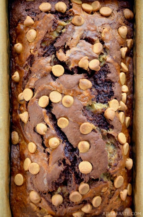 A top down view of a loaf of Chocolate Peanut Butter Banana Bread studded with peanut butter chips