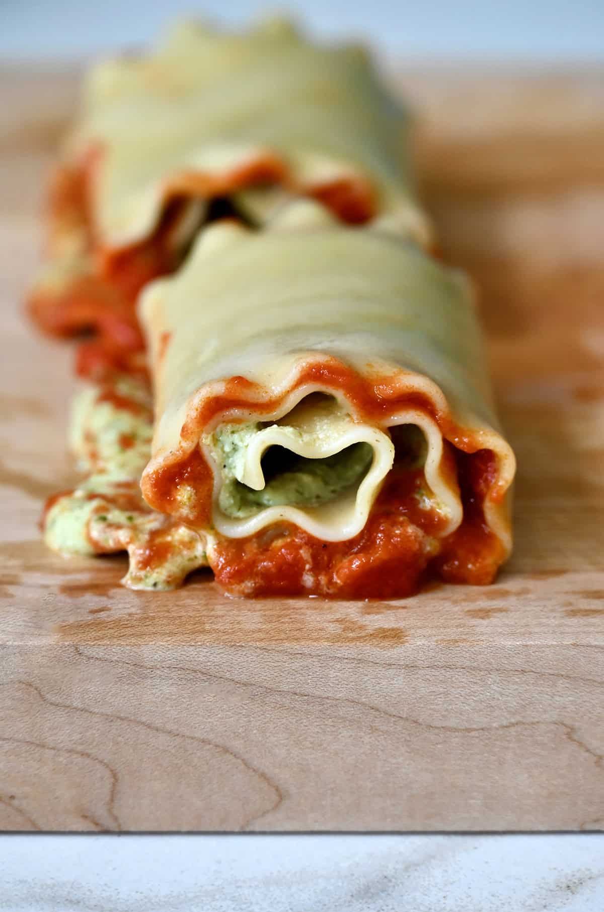 A close-up view of a lasagna roll up.