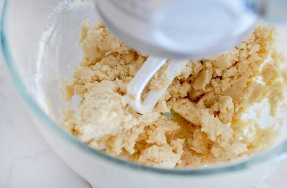 Glass stand mixer bowl containing samoas cookie dough