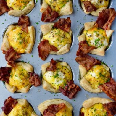 Muffin pan containing Bacon, Egg and Cheese Toast Cups