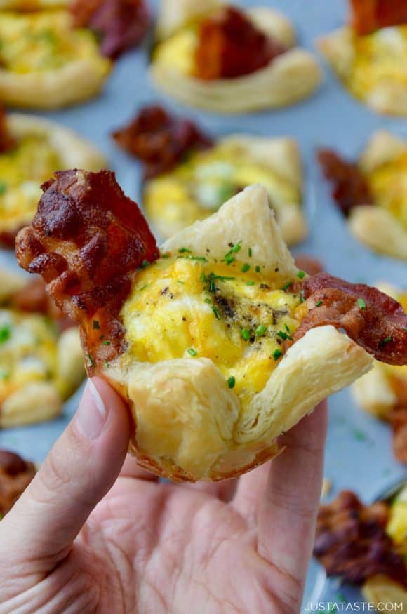 Hand holding bacon, egg and cheese toast cup