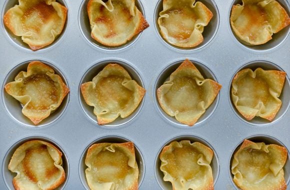 Muffin tin with baked wonton wrapper cups 
