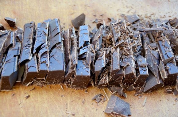 Chopped semisweet chocolate on wood cutting board