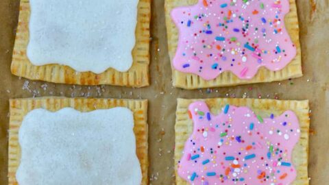 Top down view of Homemade Pop Tarts Two Ways with child's hand