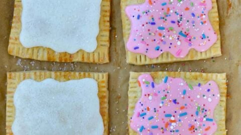 Top down view of Homemade Pop Tarts Two Ways with child's hand