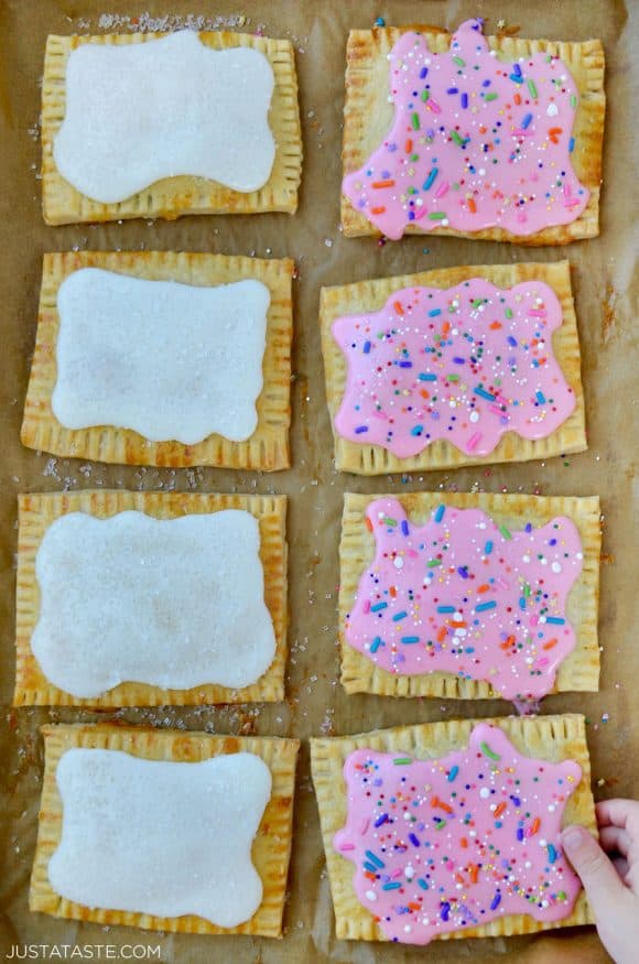 Top down view of Homemade Pop Tarts Two Ways with child's hand