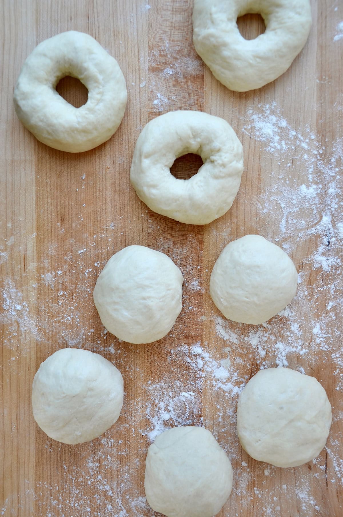 Shaping dough into bagels.