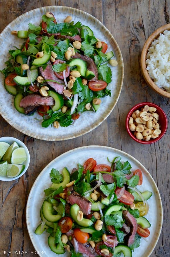 Two plates containing easy Thai Beef Salad with Lime Dressing garnished with peanuts