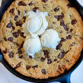 Top down view of The Ultimate Skillet Chocolate Chip Cookie topped with vanilla bean ice cream
