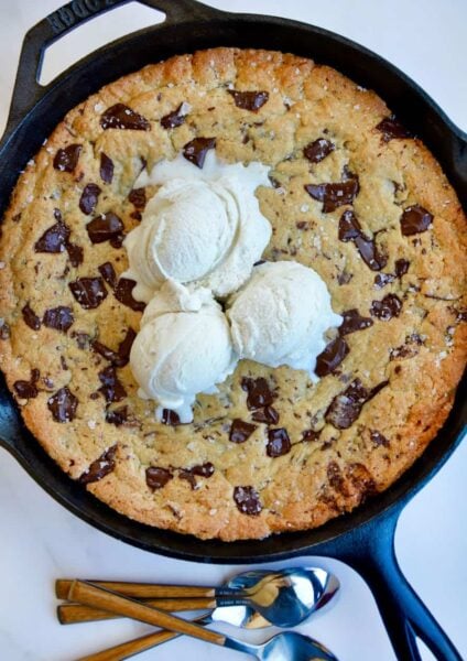 Top down view of The Ultimate Skillet Chocolate Chip Cookie topped with vanilla bean ice cream