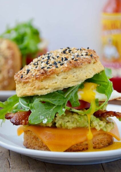 The Ultimate Biscuit Breakfast Sandwich with arugula, avocado, bacon and tomato