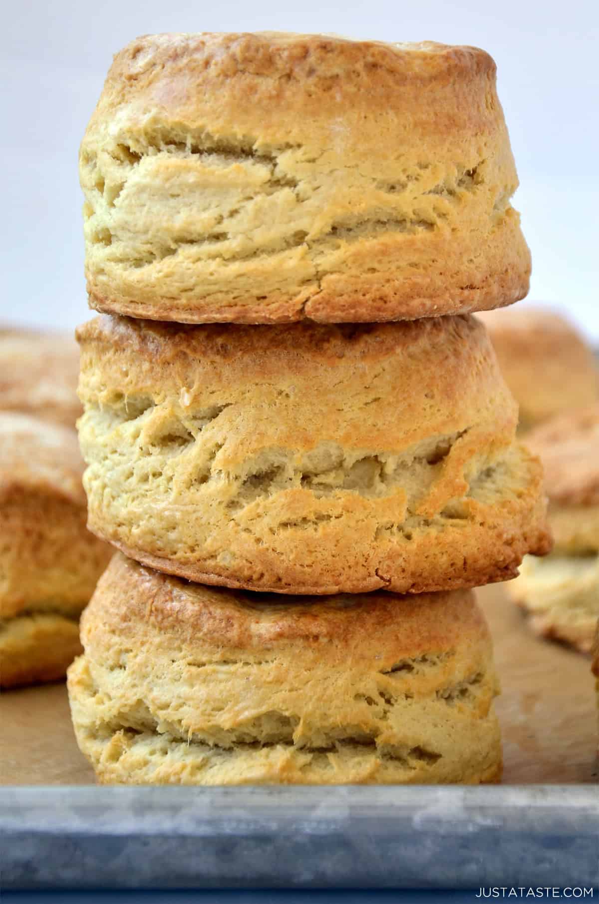 A stack of three homemade flaky buttermilk biscuits.