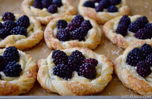 Rows of blackberry cream cheese pastries on a baking sheet