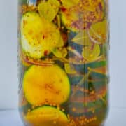 Mason jar filled with Bread and Butter Zucchini Pickles.