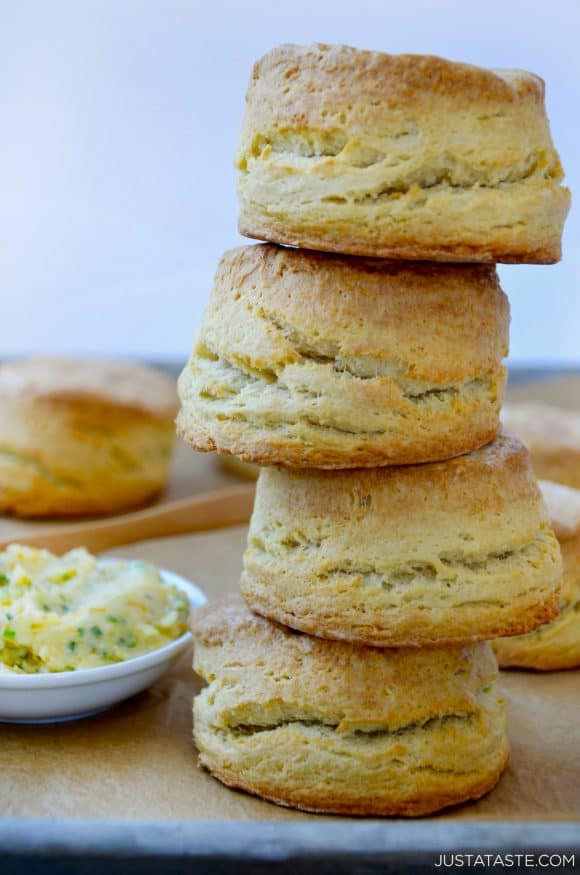 Easy Homemade Buttermilk Biscuits stacked four high next to dish with honey butter