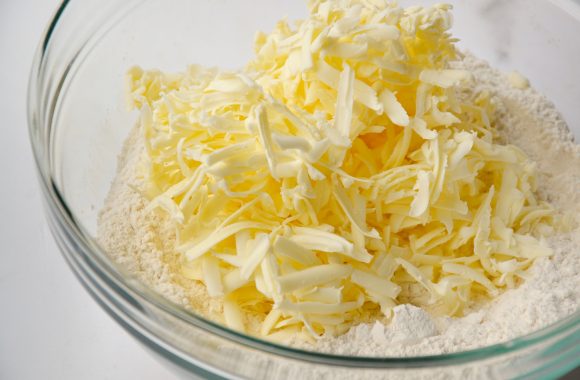 Clear bowl with grated butter and flour