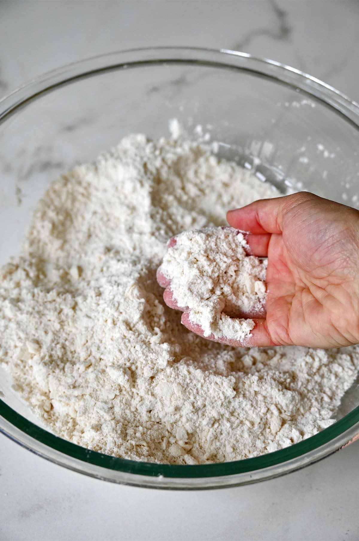 Grated butter worked into a flour mixture.