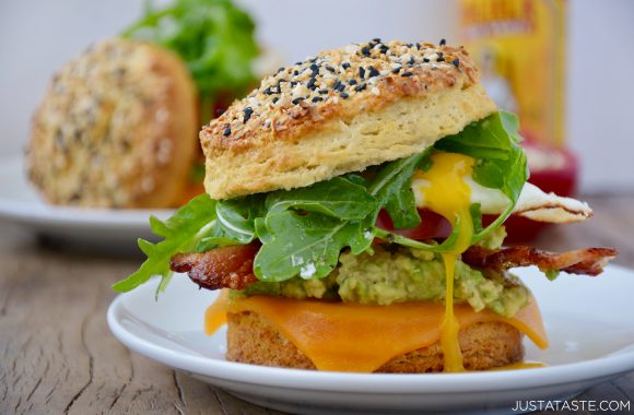 Easy homemade biscuit breakfast sandwich with melted cheddar cheese, bacon, avocado and arugula